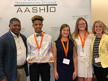 DOTD Secretary Shawn Wilson pictured with student team—Connor, Victoria, and Elizabeth—from STEM Magnet Academy of Pointe Coupee, led by teacher Lindsay Stagg.