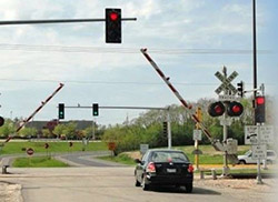 photo of cars stopped at railroad crossing
