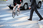 photo of pedestrian and biker in crosswalk