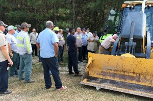 photo of workers learning about heavy equipment operation