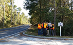 Image of public road workers in orange safety vests